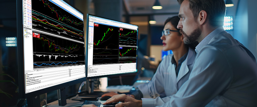 A man and woman, both forex traders, observe trading data on their screens, highlighting market volatility trends and how to stay calm during market volatility.